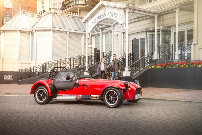 Red Caterham 7 2016 310 R parked outside hotel
