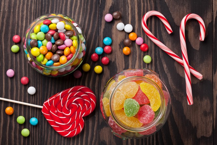 Assortment of candies and lollipops on a wooden table