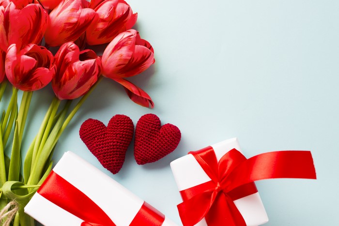 Red Tulips, Gifts, and Hearts on Light Blue Background
