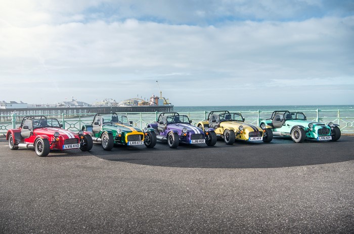 Multiple Caterham 7 cars parked by the sea