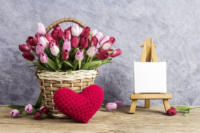 Tulips in a wicker basket with a heart and easel