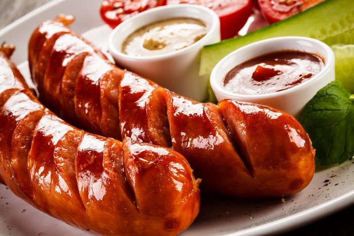 Grilled sausages with dips and vegetables