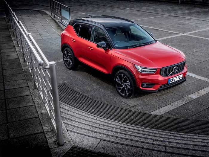 Red Volvo XC40 D4 R-Design parked on pavement