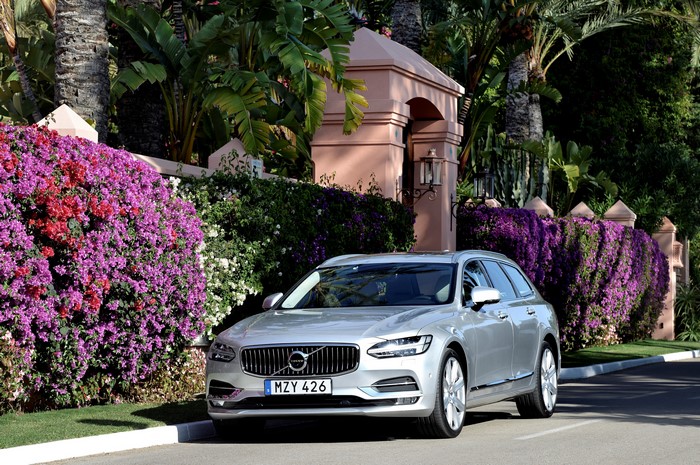 Silver Volvo V90 D5 Inscription parked by flowers