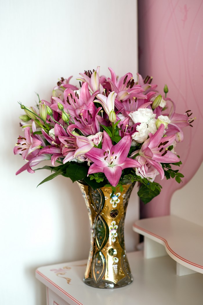 Pink lilies and white roses in a decorative vase