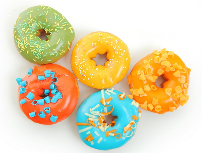 Assorted colorful donuts with sprinkles and toppings
