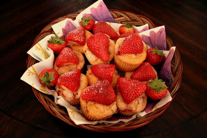 Muffins with strawberries in a wicker basket
