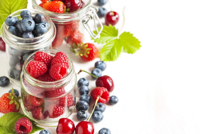 Berries in Jars on White Background