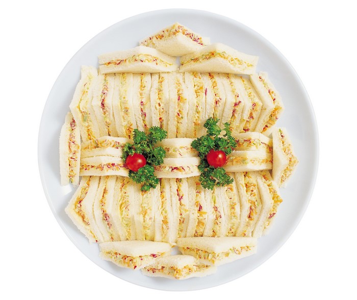 Plate of cut sandwiches with garnish