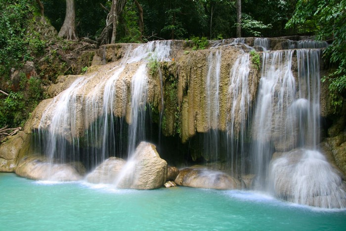 Multi-tiered waterfall cascading into turquoise water