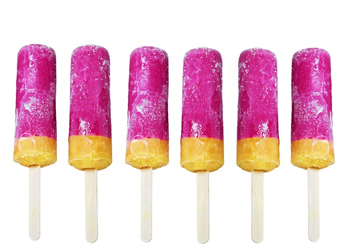 Six pink and yellow ice pops on sticks