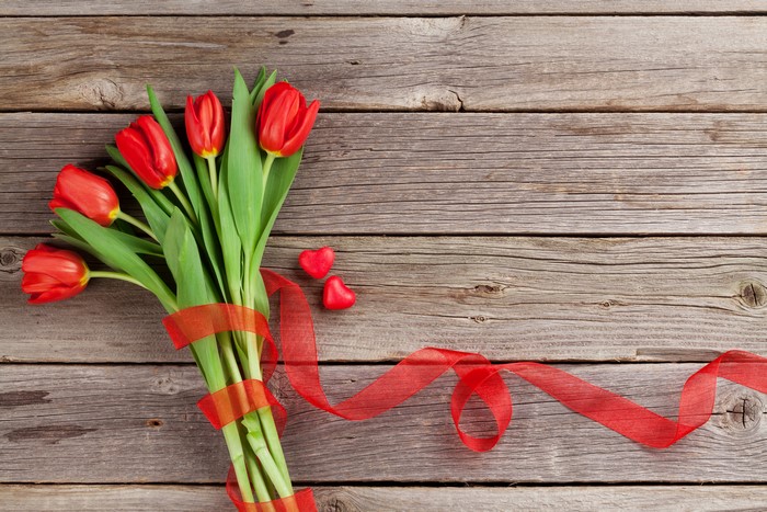 Red Tulips with Ribbon and Hearts on Wood