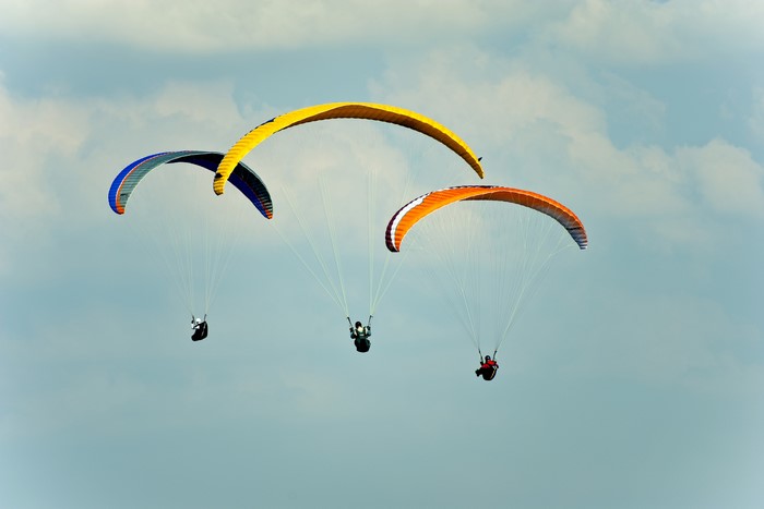 Three paragliders in the sky