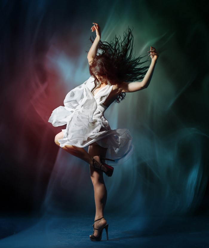 Woman in white dress dancing