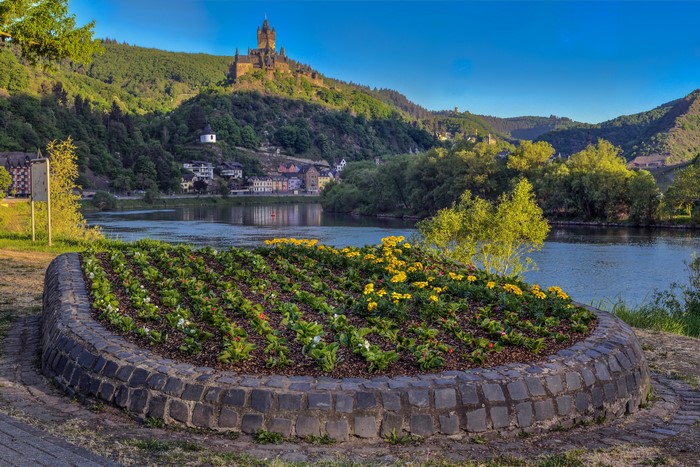 Castle on a hill overlooking a river and town