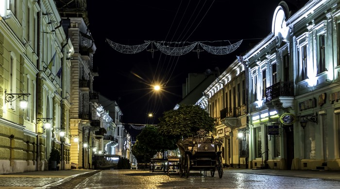 Street at night with carriage in Chernivtsi, Ukraine