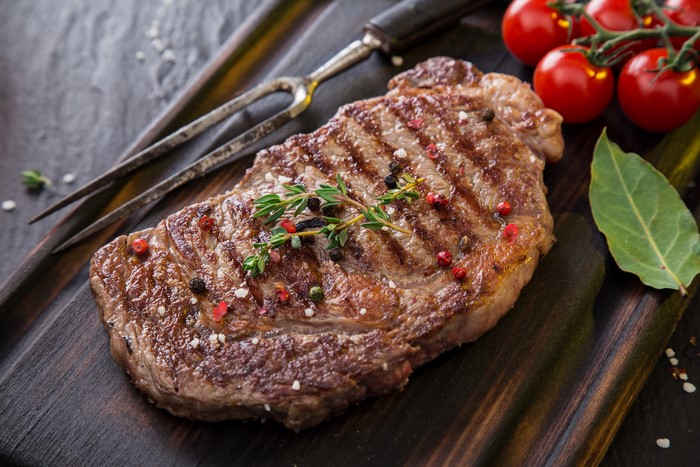 Grilled steak with cherry tomatoes and herbs
