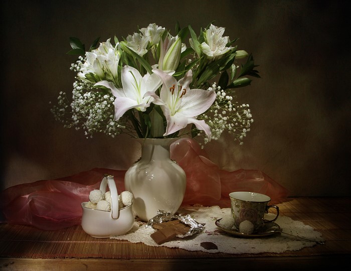 Still-life with lilies, chocolate, and tea cup