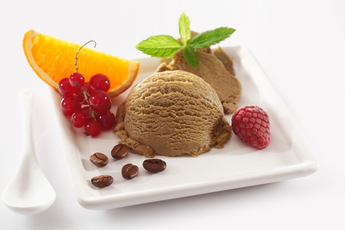 Coffee ice cream with orange, currants, raspberry, and coffee beans