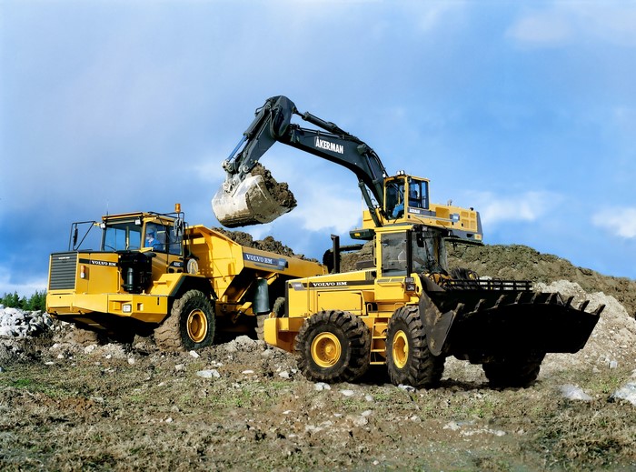 Volvo BM dump truck and excavators on a construction site