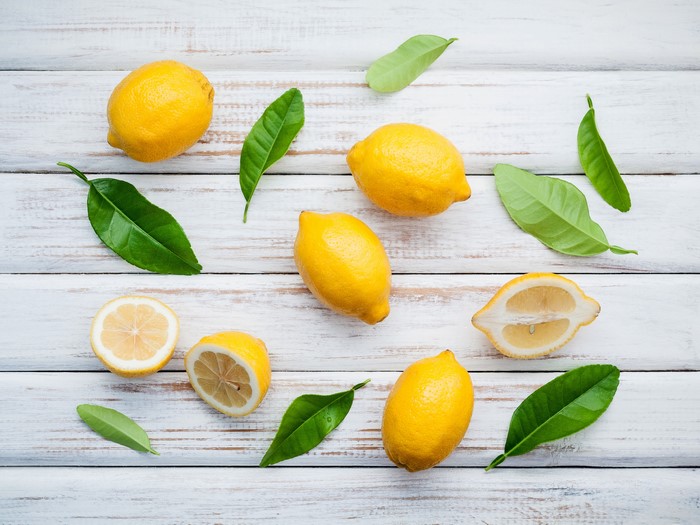 Lemons and Leaves on White Wood
