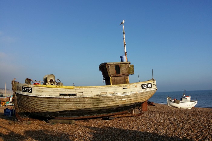 Two old fishing boats on a pebble beach