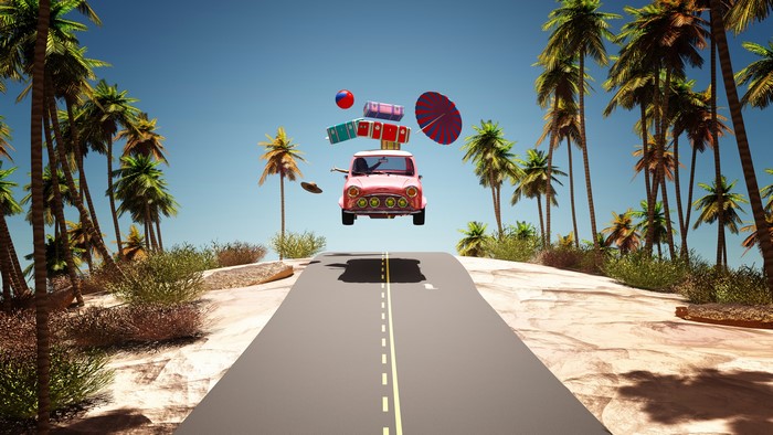 Pink car with luggage flying over a road with palm trees