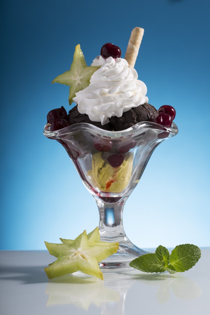 Ice cream sundae with cherries and star fruit