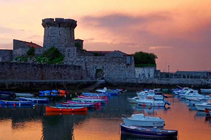 Fort de Socoa fortress with boats at sunset