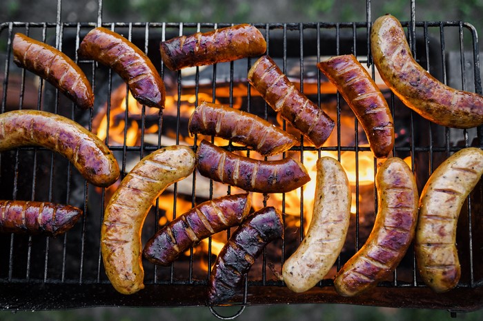 Sausages grilling over an open fire