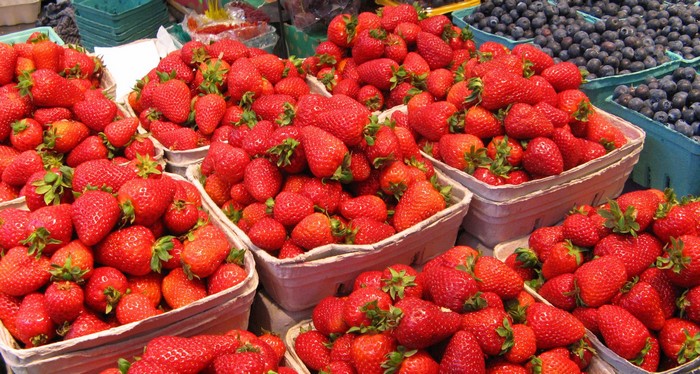 Baskets of Strawberries and Blueberries at a Market