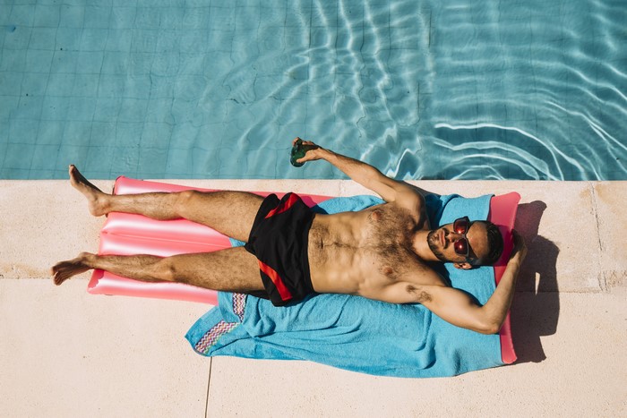 Man in Sunglasses Lying on Inflatable Pool Float