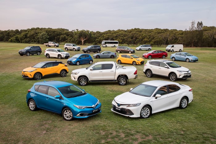 Toyota cars parked on a grassy field