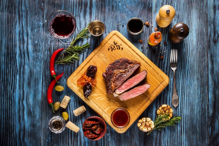 Sliced Steak with Wine and Spices on Cutting Board