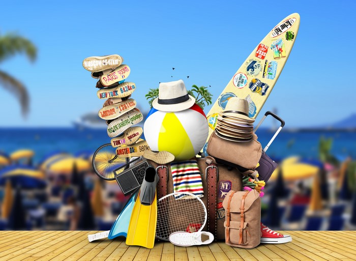 Travel items on a beach background