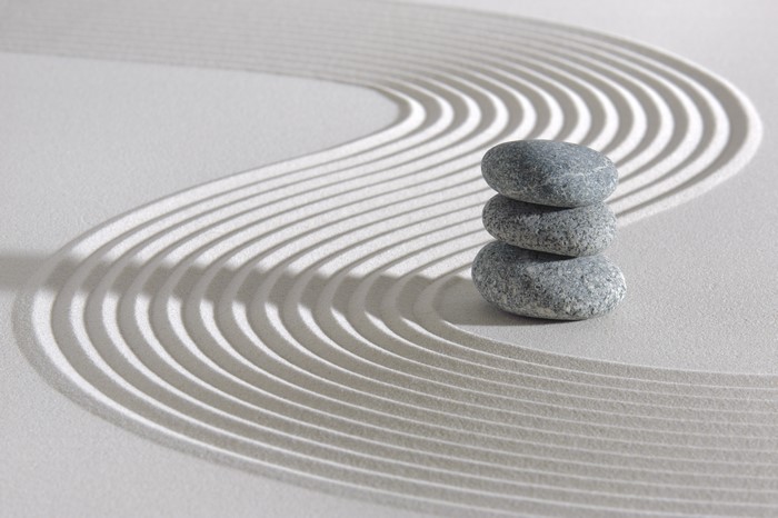 Zen garden with stacked stones and raked sand