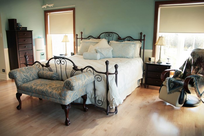 Bedroom with bed, bench, dresser, and chair