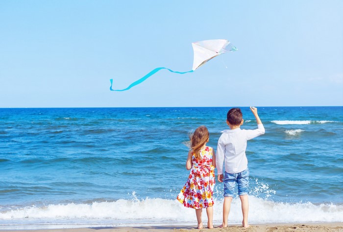 Children flying a kite on the beach