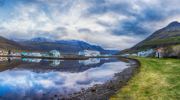 Icelandic village with cruise ship and mountains