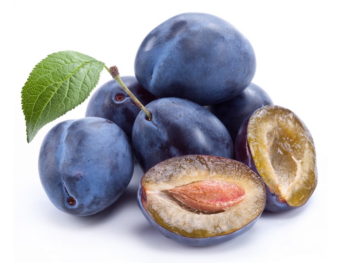 Plums with a leaf on a white background
