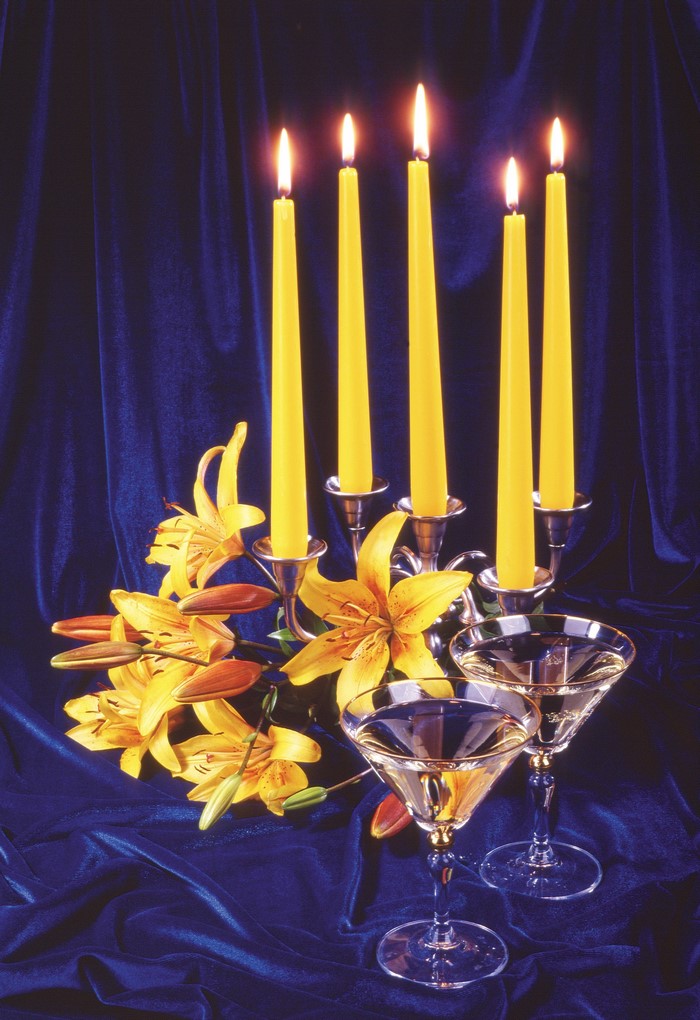 Still-life with lit candles and lilies