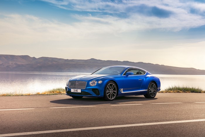 Blue Bentley Continental GT on a road by the water