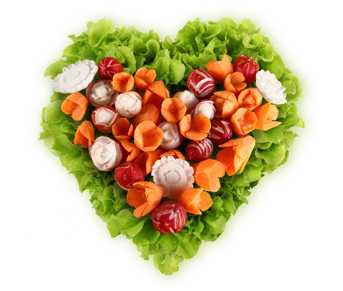 Heart shape of carved vegetables on lettuce