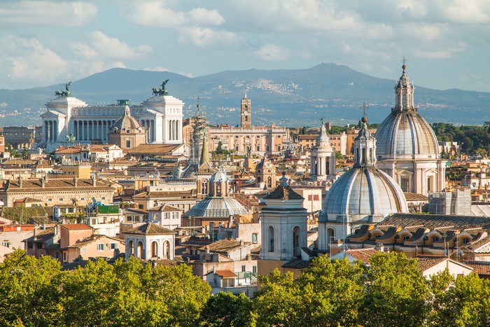 Rome, Italy cityscape with domes and mountains