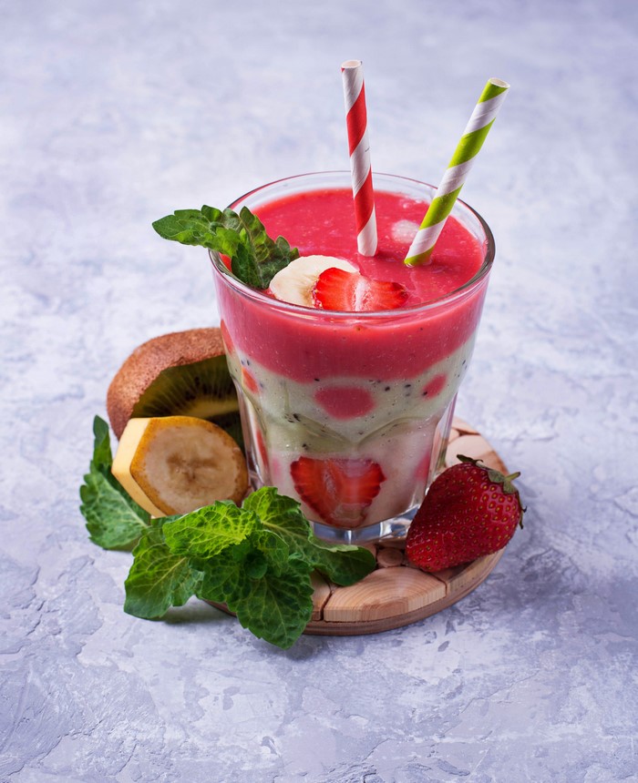 Strawberry and Kiwi layered smoothie with fresh fruit