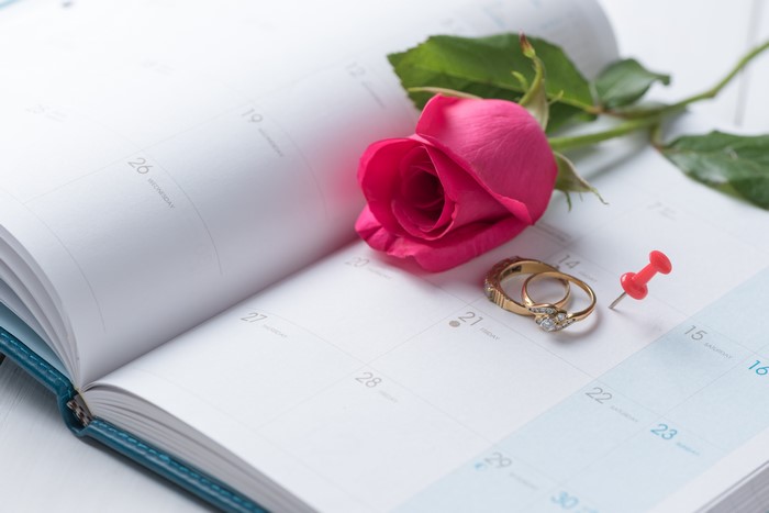 Wedding Rings and Rose on a Calendar