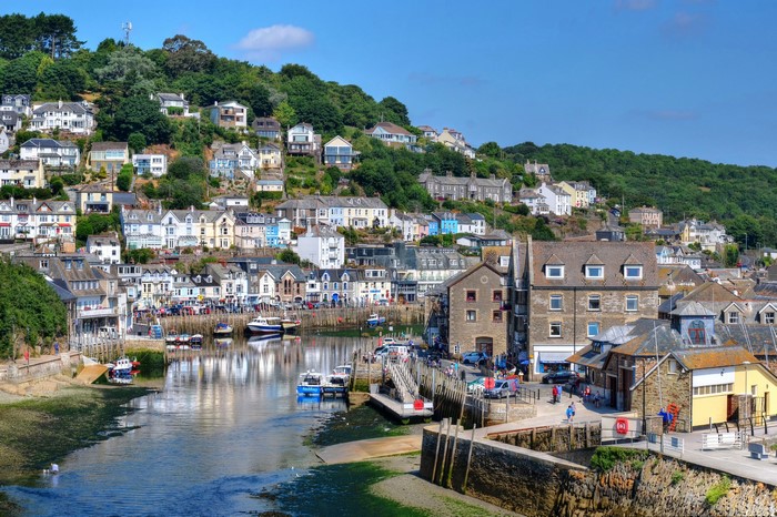Looe, England harbor with houses on a hill