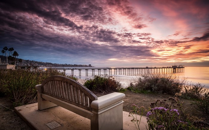 Bench overlooking La Jolla pier at sunset, California