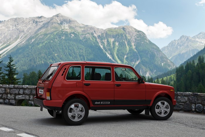 Red Lada Niva Urban 4x4 car in mountains
