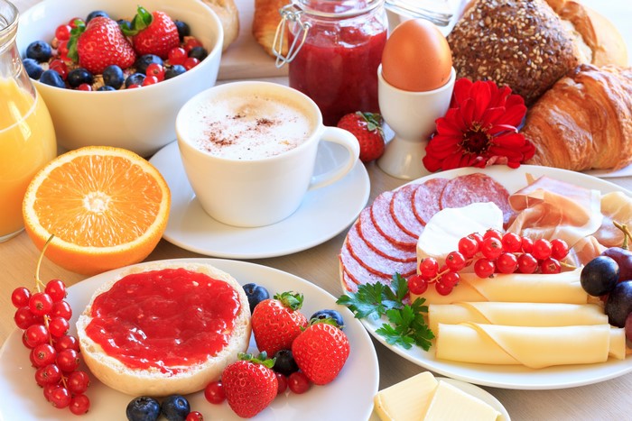 Breakfast with Cappuccino, Fruits, and Meats